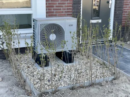 Wärmepumpen-Außeneinheit an einem modernisierten Gebäude